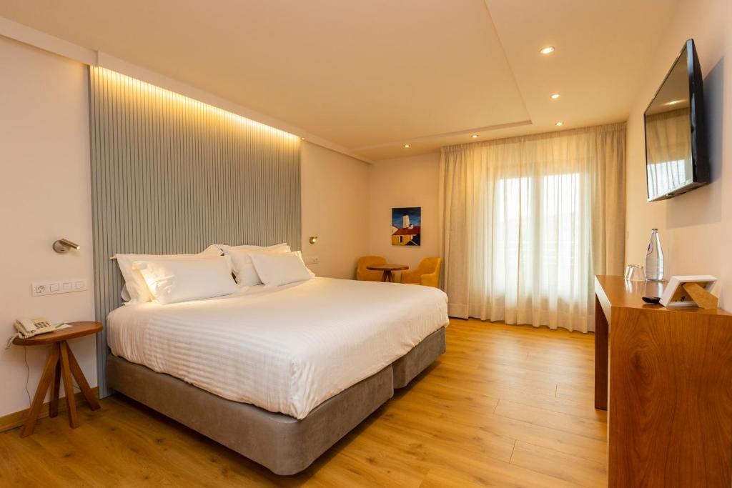 Postel nebo postele na pokoji v ubytování Hotel O Cabazo
