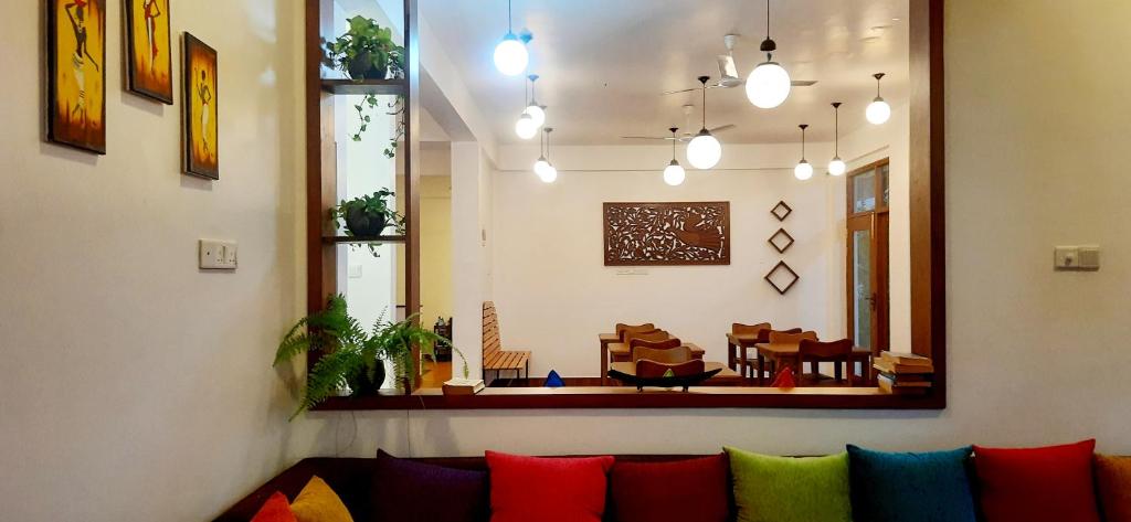 - un salon avec un canapé et des oreillers colorés dans l'établissement Hemalie Resort Mirissa, à Mirissa