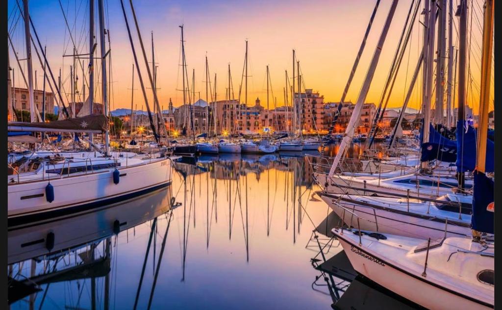 a group of boats docked in a harbor at sunset at Lunablu Boat&Sail in Palermo