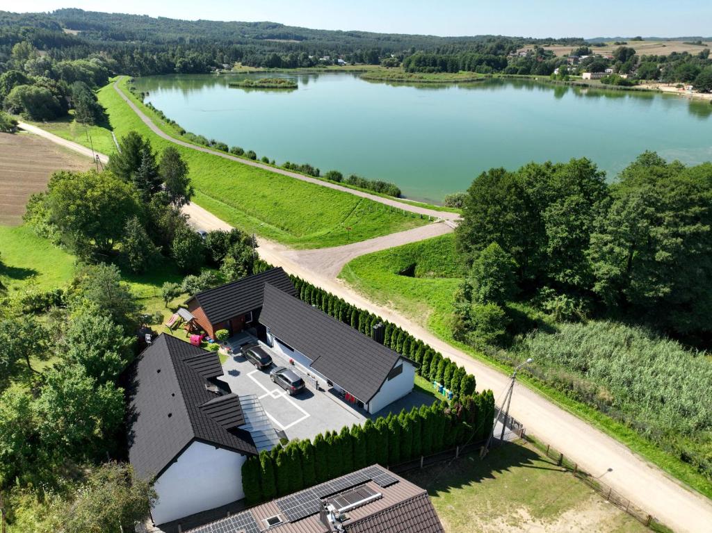 an aerial view of a house next to a lake at Apartamenty na Jurze in Siamoszyce