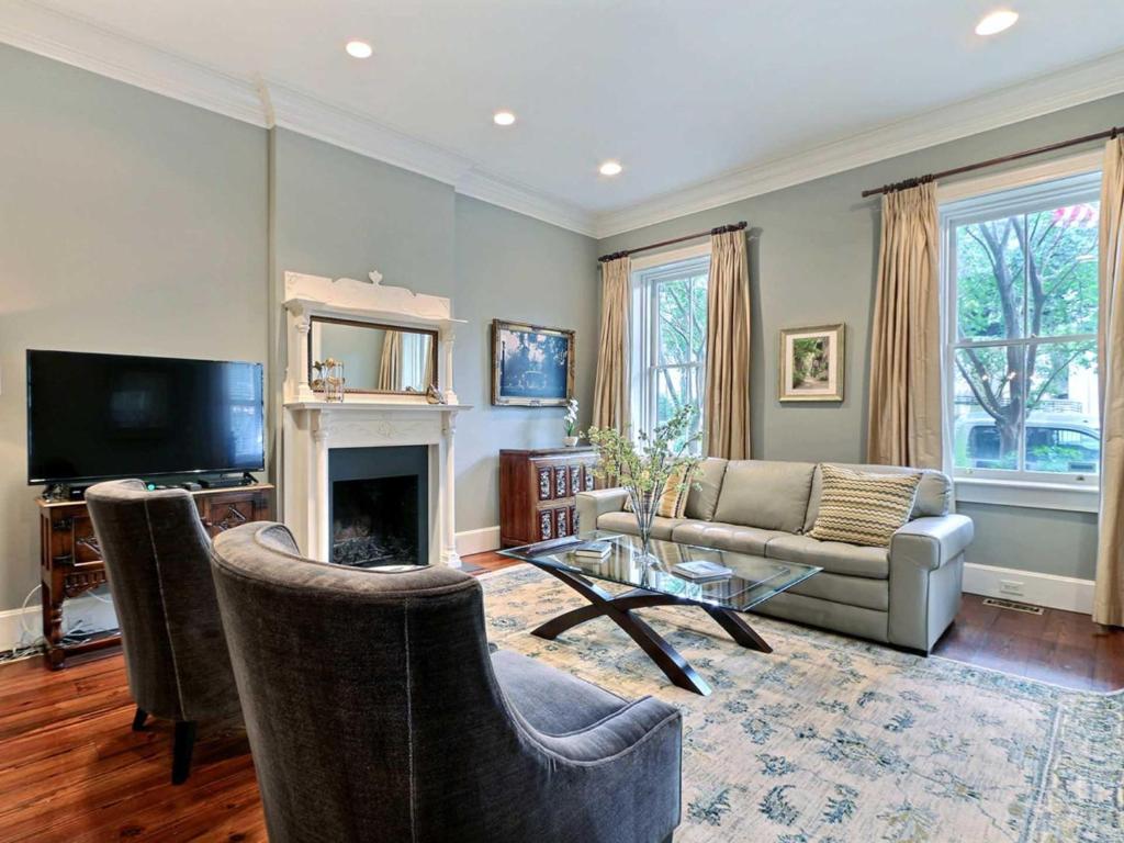 a living room with a couch and a fireplace at Habersham House in Savannah