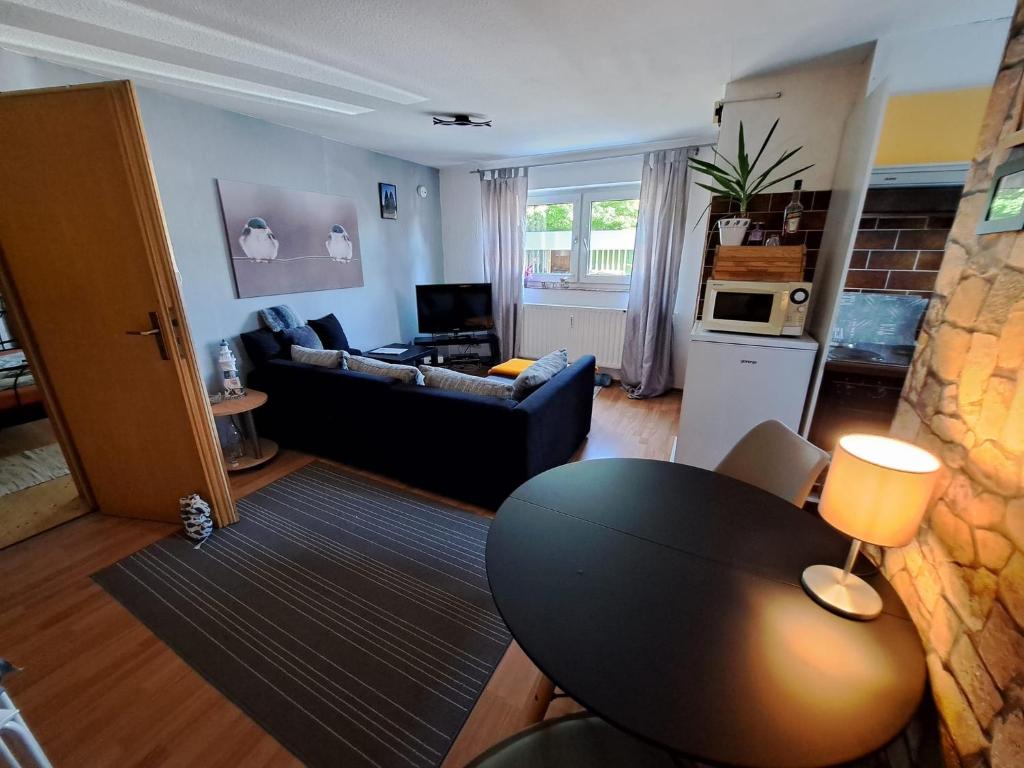 a living room with a table and a couch at Zur Steinhöhle Nümbrecht in Nümbrecht