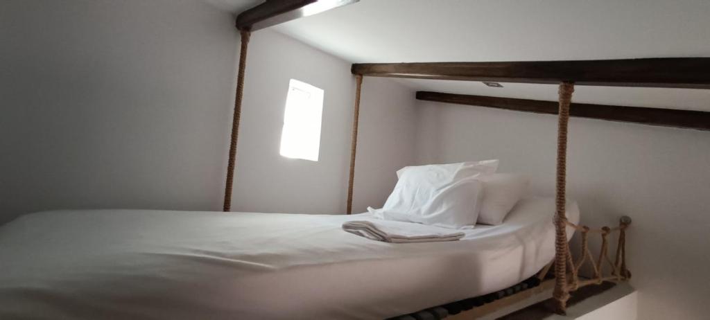 a bedroom with a bed with a wooden frame at Boutique Eptalofos 15min from airoport and sea in Kouvarás