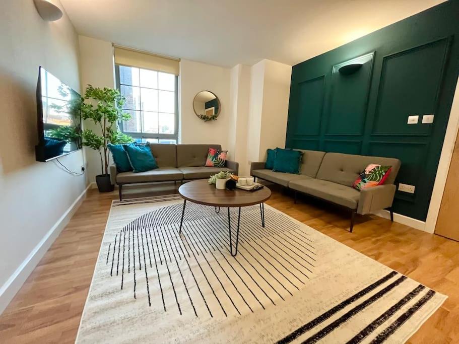 a living room with a couch and a table at Spacious 2 Bedroom Apartment with Parking in Nottingham