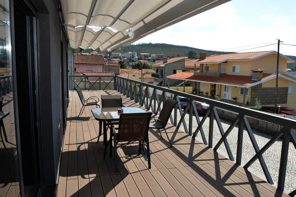 a balcony with a table and chairs on a balcony at A3J Country House Lagares in Penafiel