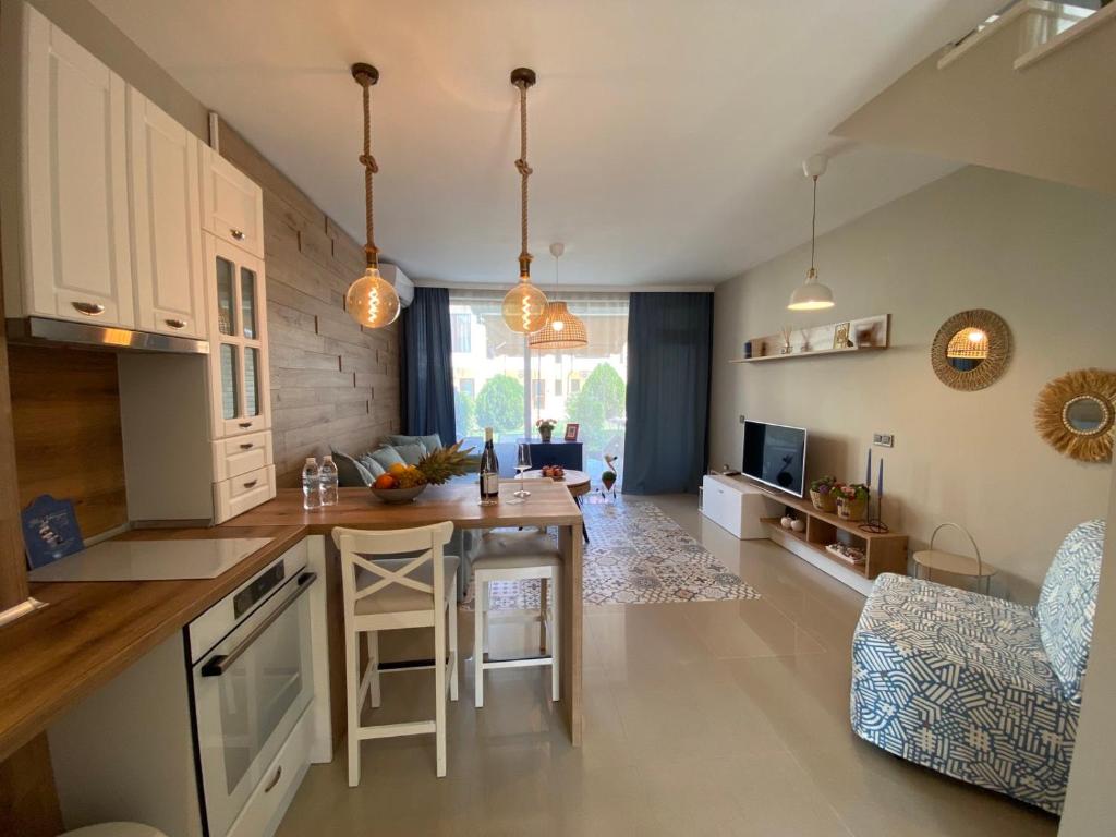 a kitchen with a table and a dining room at Villa Lavanda Golf in Balchik