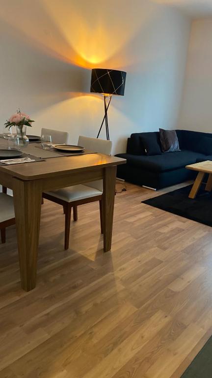 a living room with a wooden table and a couch at City Fever in Hannover