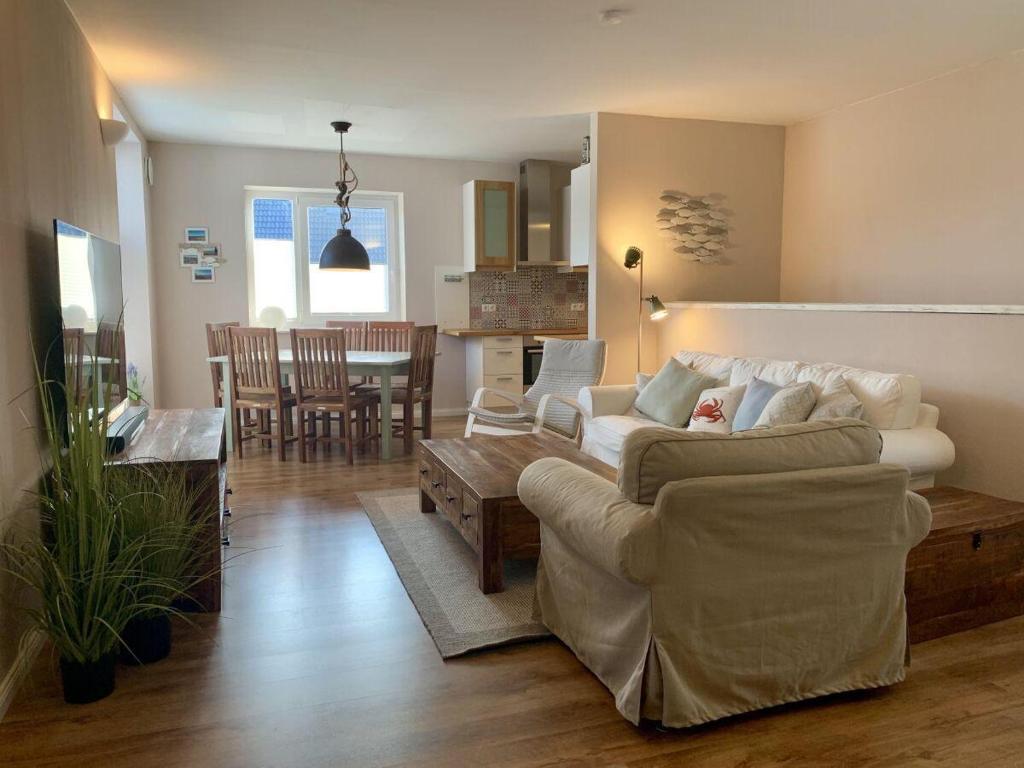 a living room with two couches and a dining room at Ferienwohnung-Seepferdchen-Finnlandring in Timmendorfer Strand