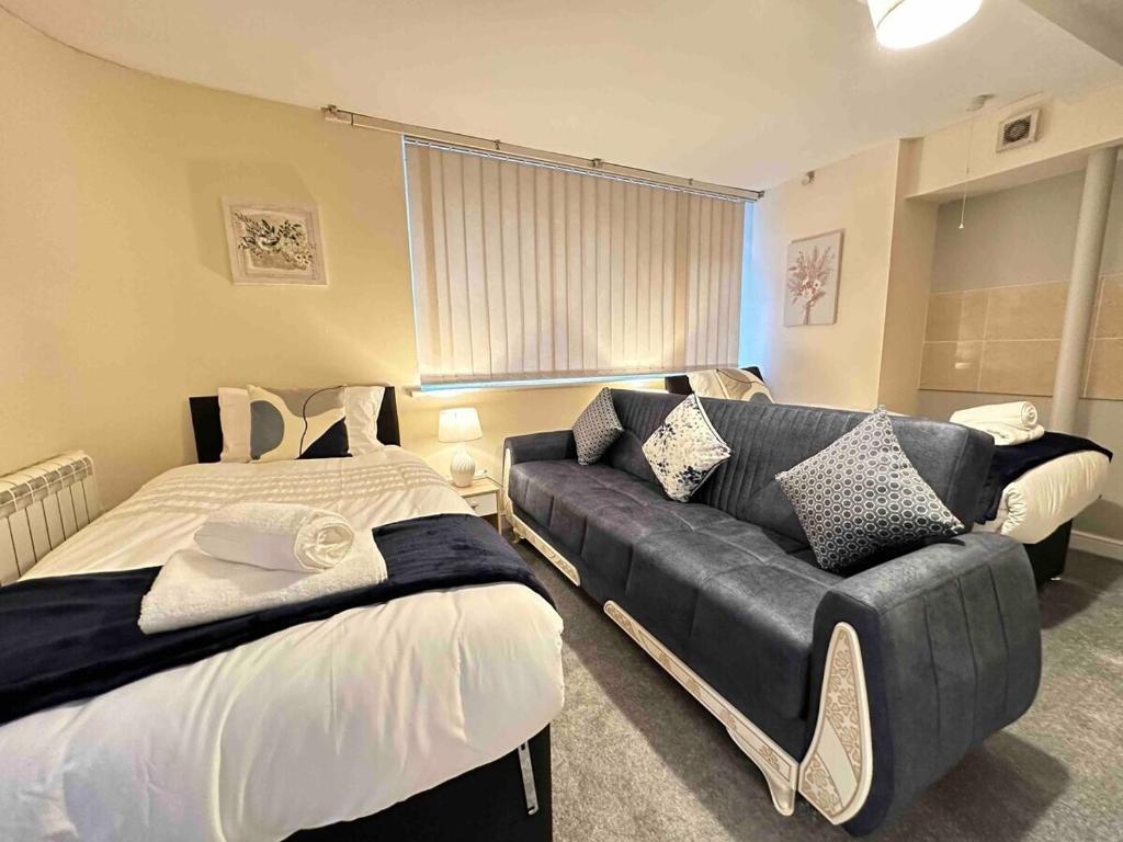 um quarto com uma cama e um sofá em City Stay em Colchester