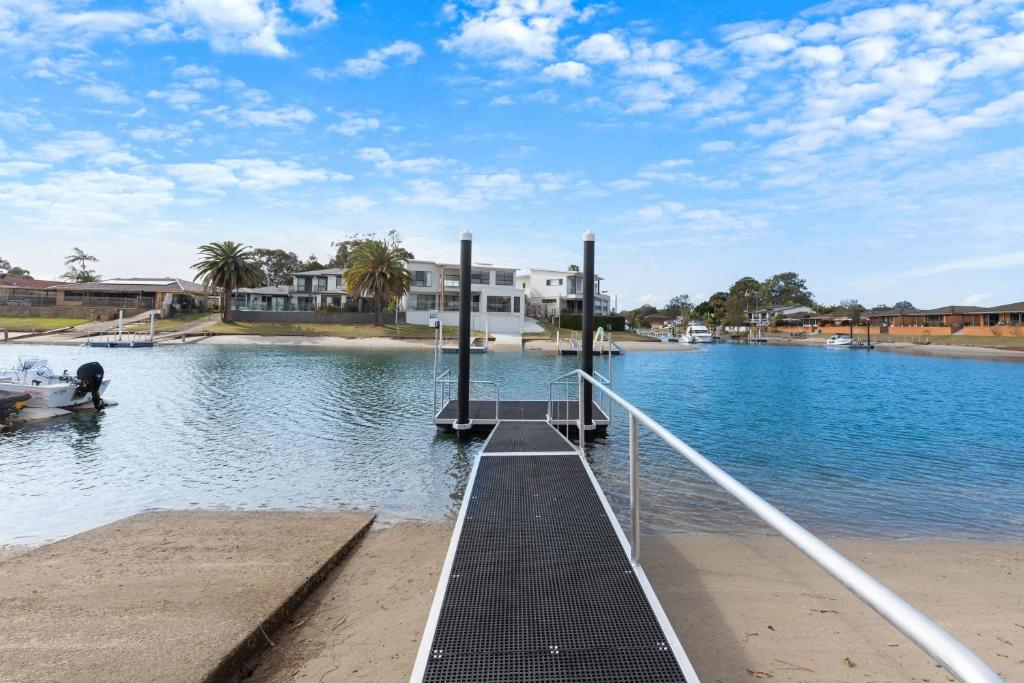 a dock in the middle of a body of water at Hibbard 12 in Port Macquarie