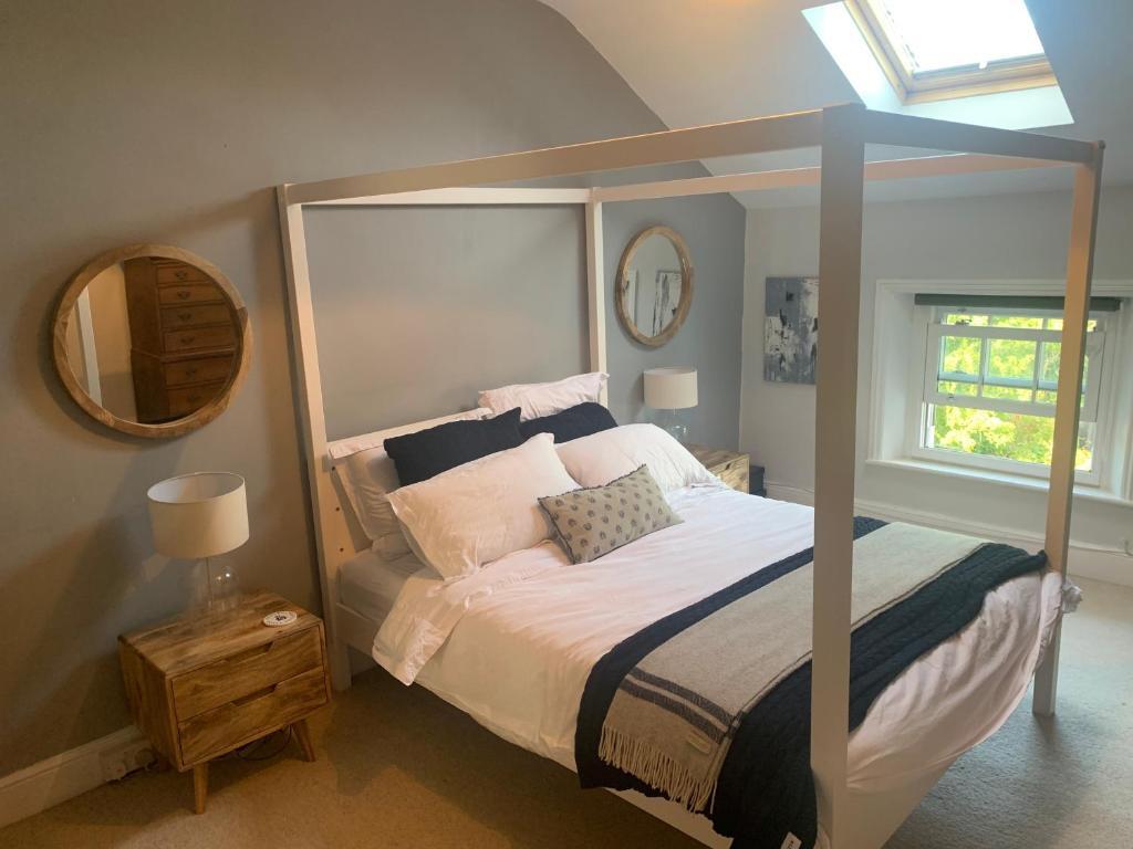 a bedroom with a large bed and a mirror at Top Floor. Top Notch. Tranquil Treat. Stone's throw from Thames. in Maidenhead