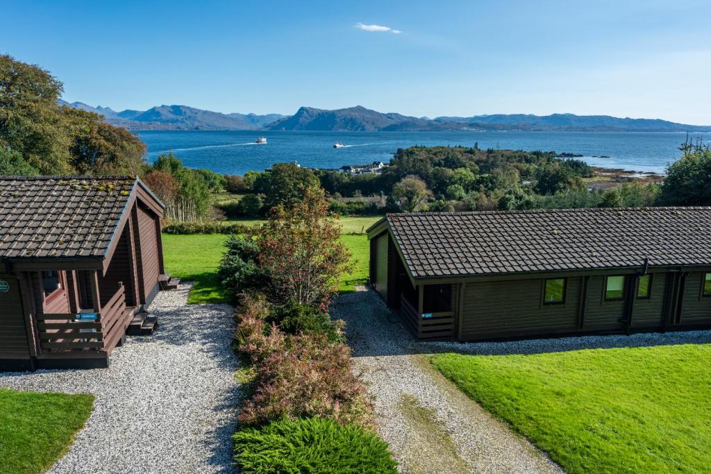 a couple of buildings with a view of the water at Armadale Castle Cabins in Ardvasar