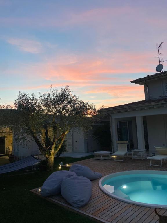 a patio with a hot tub on a wooden deck at Villa Concetta in Torre del Lago Puccini