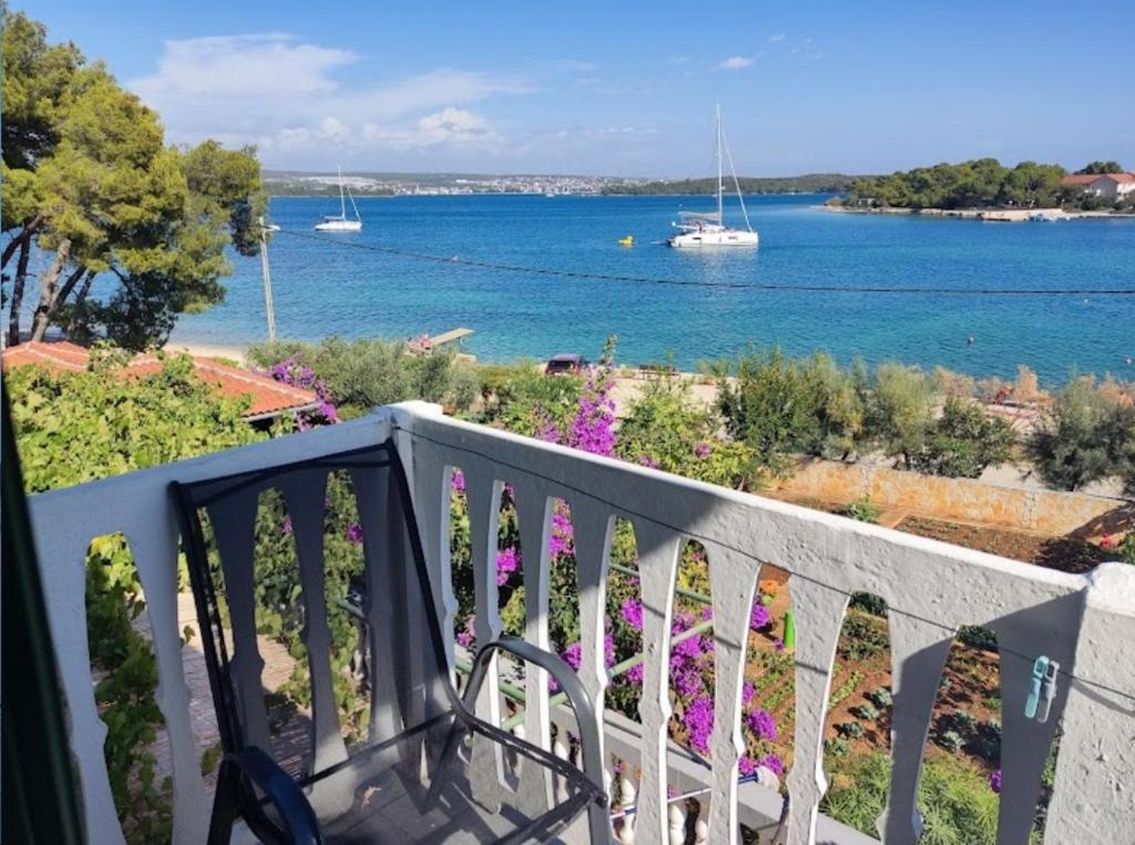 a balcony with a view of a body of water at Apartman Dragica S1 in Pašman