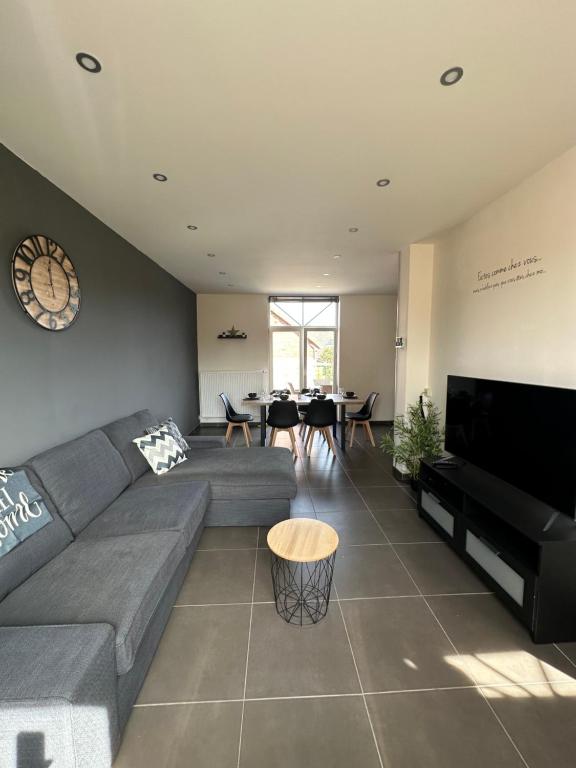 a living room with a couch and a piano at The 75 renovated work or holiday home in Comines