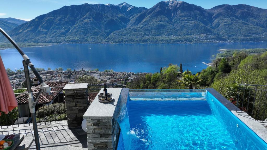 a swimming pool with a view of a lake at Casa Makatea in Brione sopra Minusio
