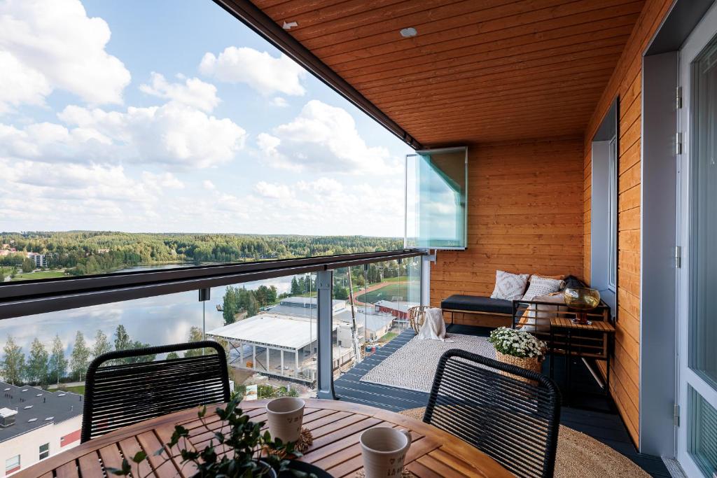 a balcony with a table and chairs and a large window at Tower Cabin in Tampere