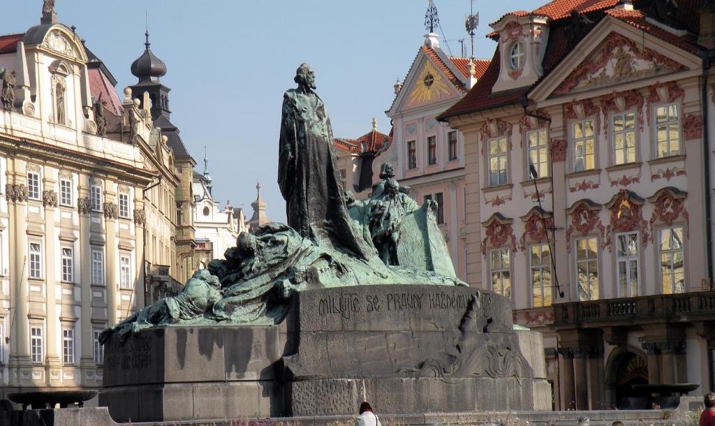 a statue in the middle of a city with buildings at BoHo Prague Hotel - Small Luxury Hotels in Prague