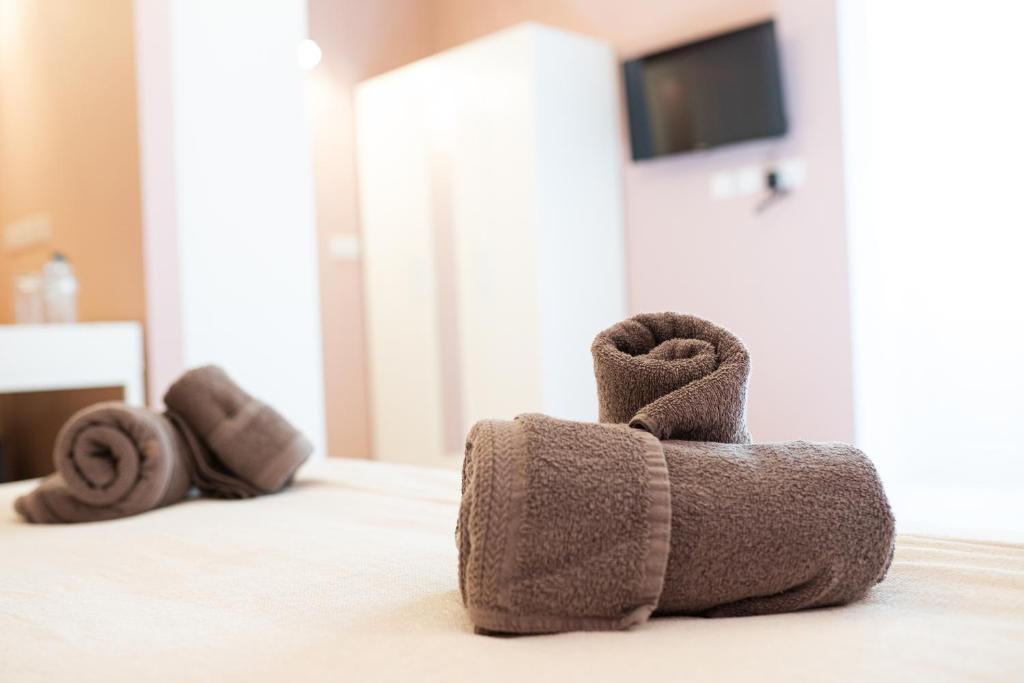 a towel animal is sitting on a bed at Three Cities Guest House in Cospicua