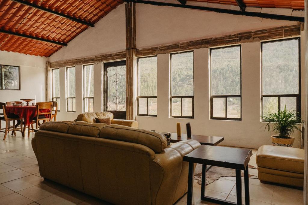 a living room with a couch and a table at Pinitos Ranch Country House in Arteaga