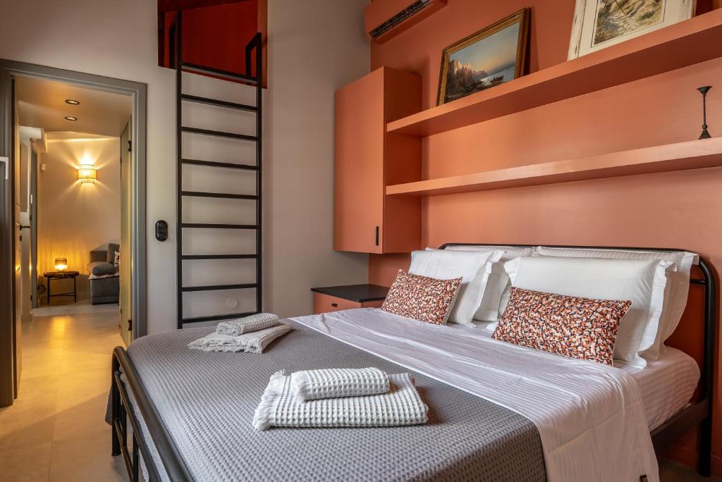 a bedroom with a large bed with shelves on the wall at Villa Hermes in Anafiotika Athens ! in Athens