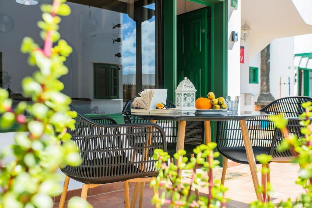 a table with chairs and fruit on a patio at Casa Luna in Puerto del Carmen