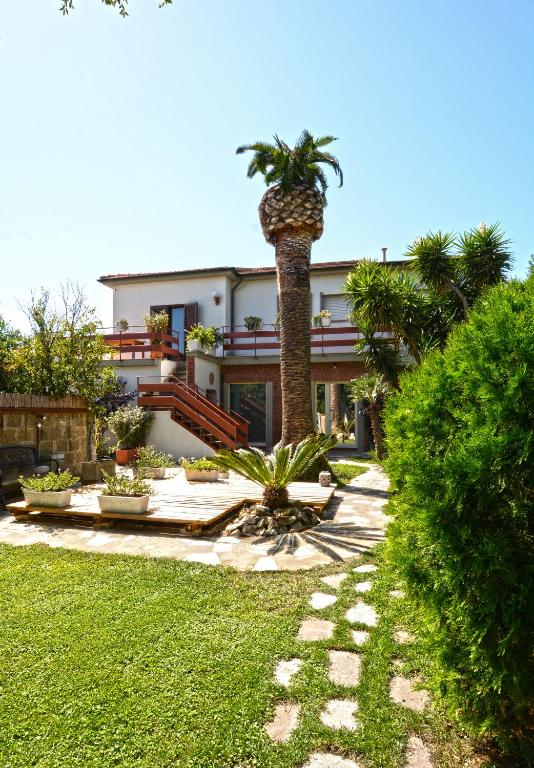 a house with a palm tree in front of it at CivicoNove in Piombino