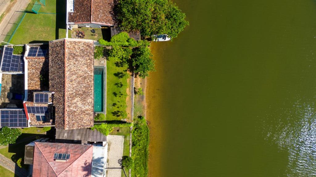 uma vista superior de uma casa ao lado de uma massa de água em Sitara Weligama em Weligama