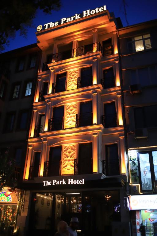 a lit up building with a sign for the park hotel at THE PARK HOTEL in Istanbul