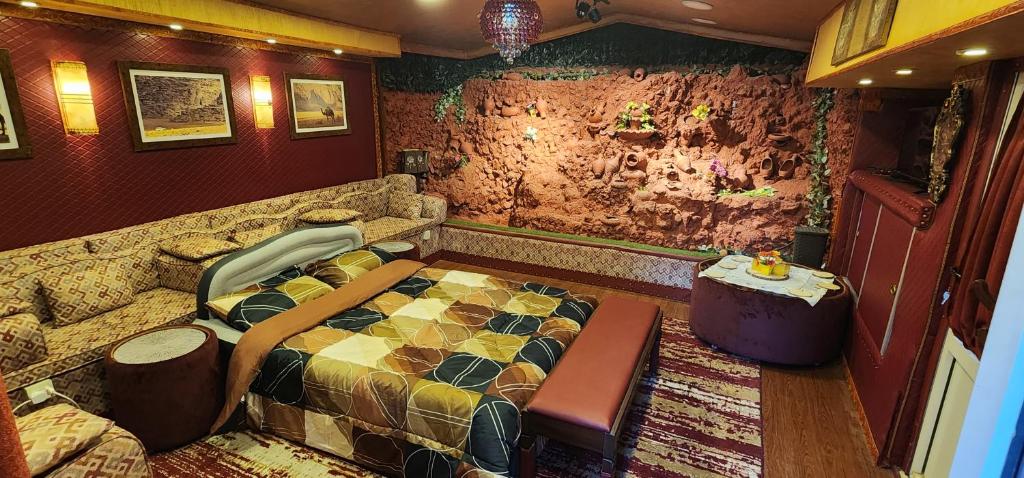 a bedroom with a bed and a table in it at Waterfall Hut - Live by a waterfall كوخ الشلال - عش وسط شلال in Amman