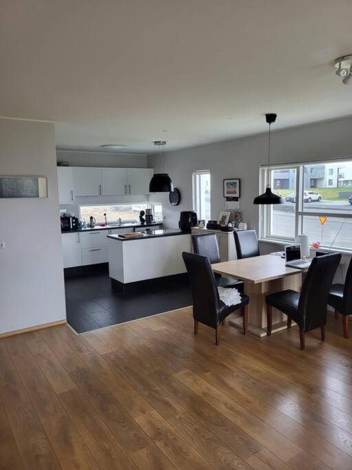 a kitchen and dining room with a table and chairs at Reynidalur apartments in Njarðvík