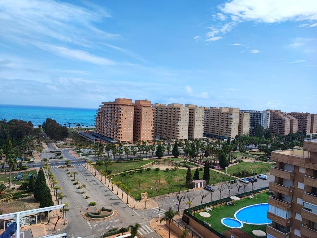 widok na miasto z wysokimi budynkami i ocean w obiekcie Apartamento con piscina Lyz y Mar w mieście Oropesa del Mar