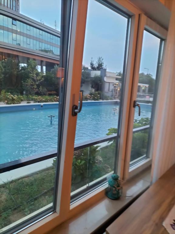 a window with a view of a swimming pool at Maltepe daire in Istanbul