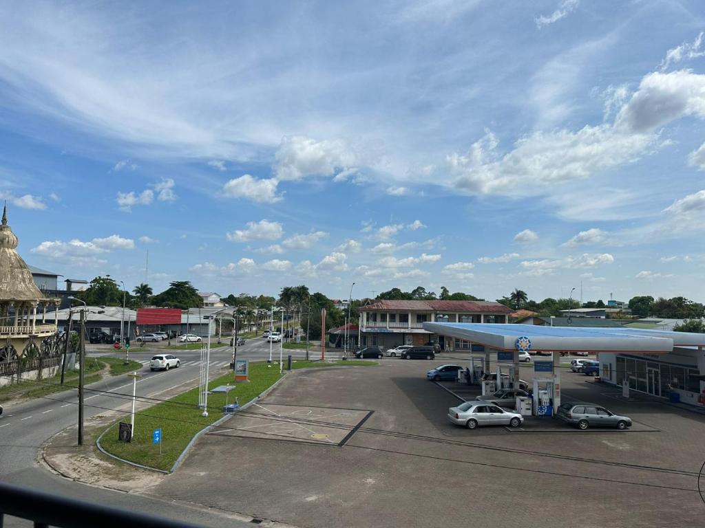 a gas station with cars parked in a parking lot at Southside Apartments in Paramaribo