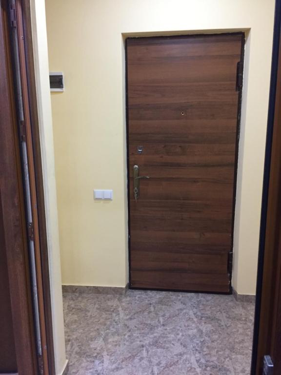 a wooden door in a room with a tile floor at ARTDELUXE in Artashat