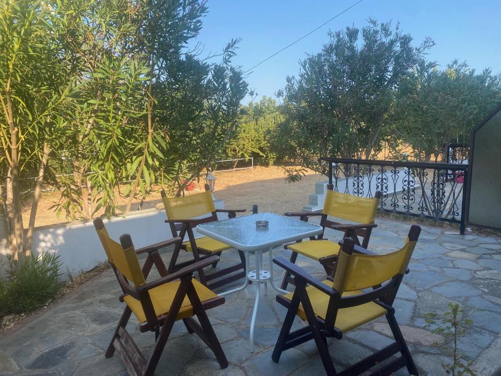 a table and chairs sitting on a patio at Blue Bay Beach Hotel in Koinyra