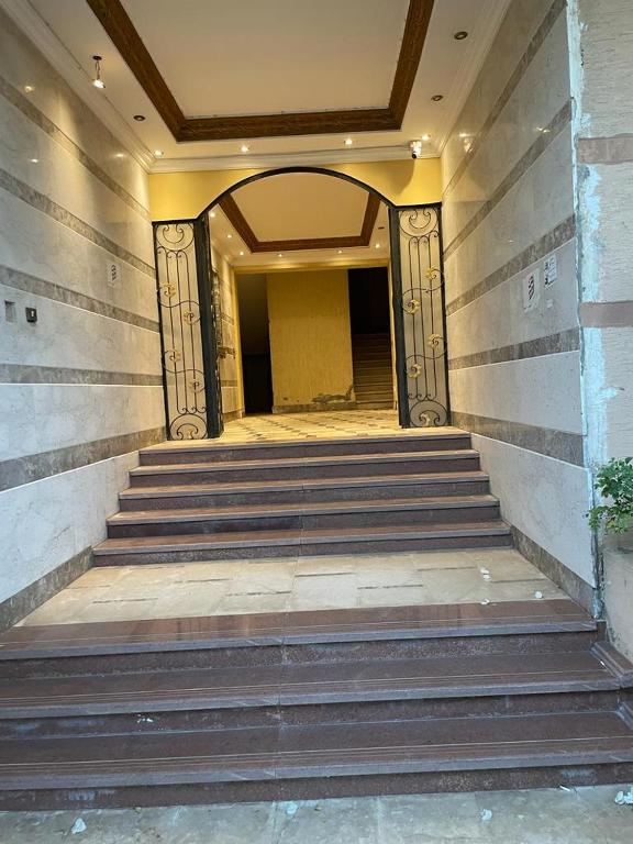a building with stairs leading to a hallway at Private roof in Cairo