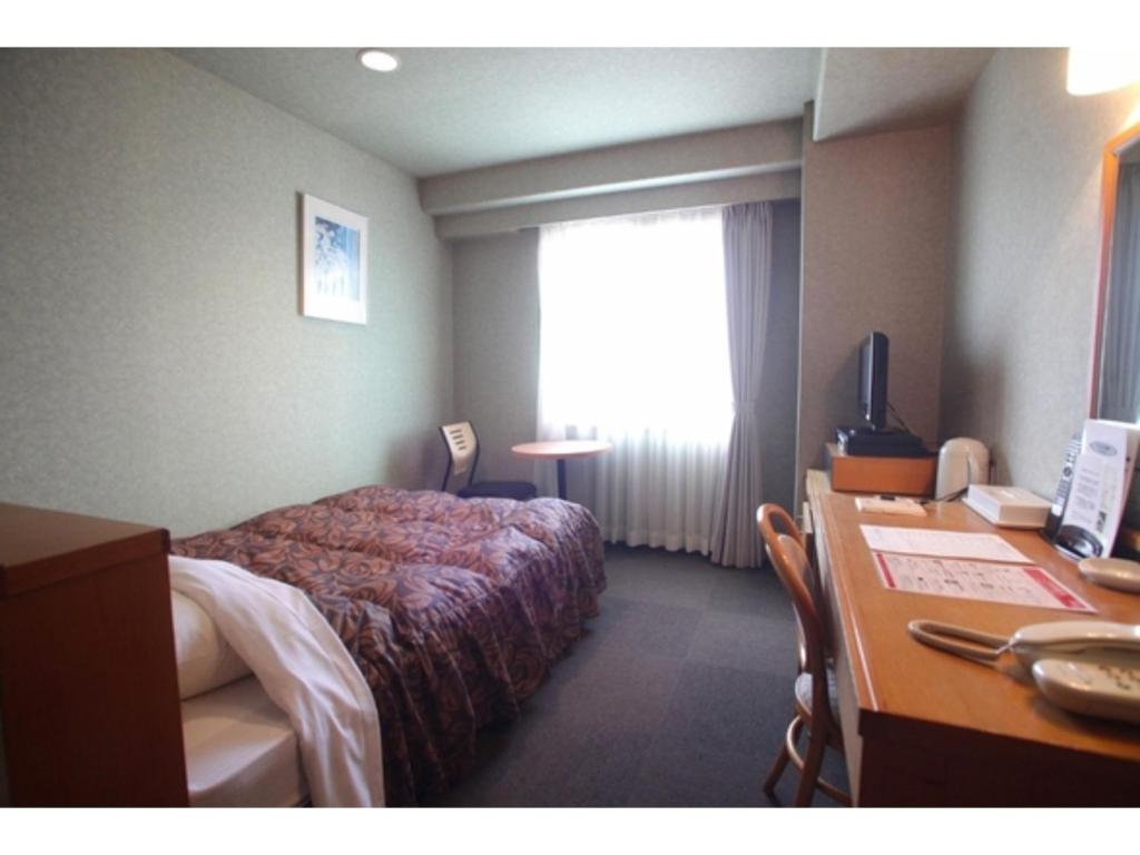 a hotel room with a bed and a desk at Hotel Socia - Vacation STAY 53776v in Hita