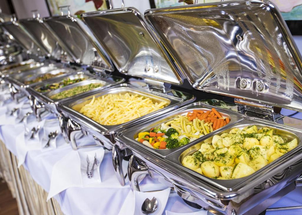 a row of trays of food on a table at Grand Lubicz Uzdrowisko Ustka in Ustka