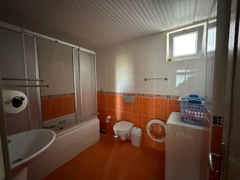 a bathroom with a sink and a toilet and a sink at Kundu'da Havuzlu Bahçeli Villa in Antalya