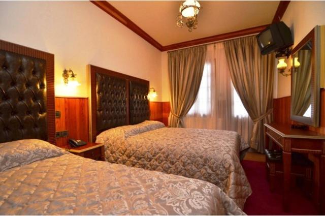 Postel nebo postele na pokoji v ubytování Hotel Apollon