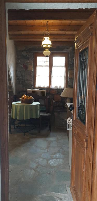 a dining room with a table and a window at Vilaeti Estia in Agios Konstantinos