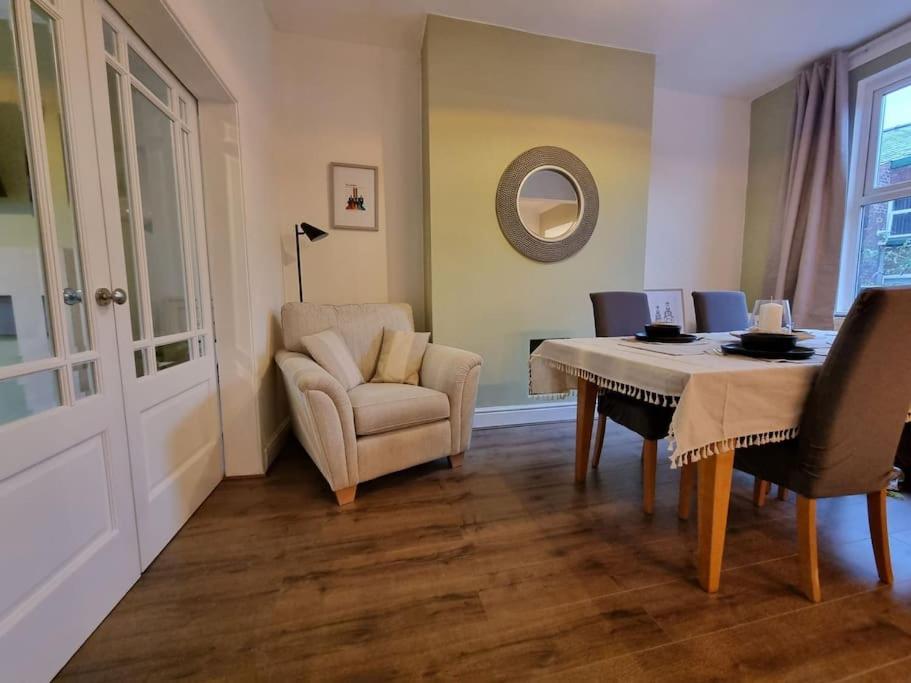 a dining room with a table and a chair at Home from Home Liverpool - Entire Home in Liverpool