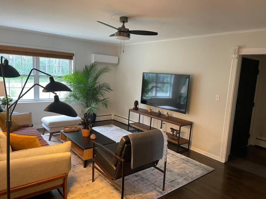a living room with a couch and a tv at Cute ranch house, less than 1 mile to downtown and skidmore. 2 miles to the track and SPAC in Saratoga Springs