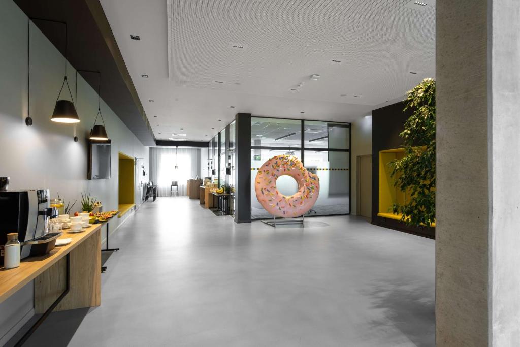a donut shop with a large donut on the wall at Park Inn by Radisson Vilnius Airport Hotel & Conference Centre in Vilnius