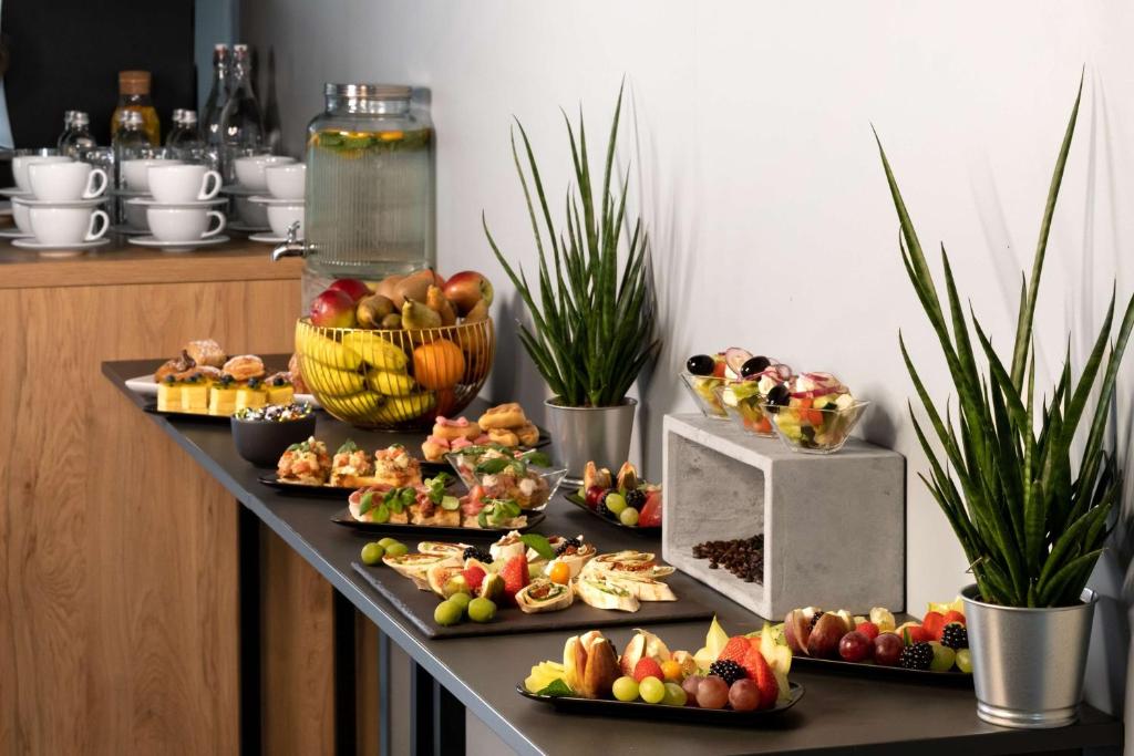 a buffet with many different types of food on a table at Park Inn by Radisson Vilnius Airport Hotel & Conference Centre in Vilnius