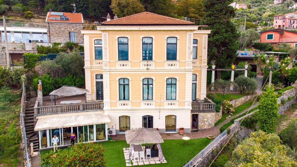 an aerial view of a large yellow house at Villa Le Palme Swimming-Pool & Relax in the Gulf of Poets in La Spezia
