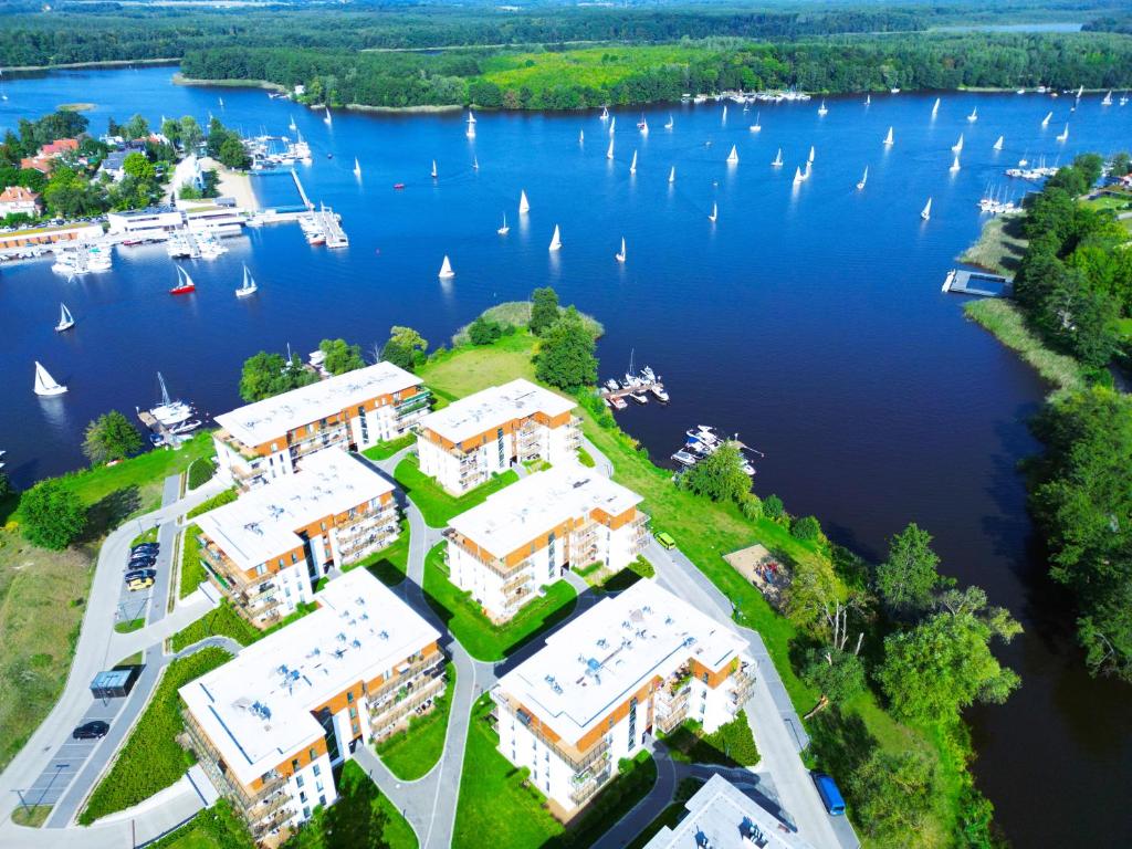 an aerial view of a resort on a lake with sailboats at Port View plus miejsce w hali garażowej in Iława