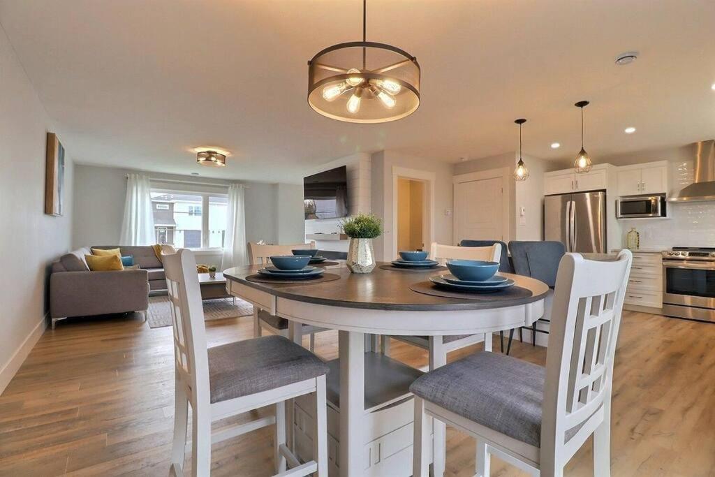 a kitchen and dining room with a table and chairs at Beautiful Home in Moncton North! in Moncton