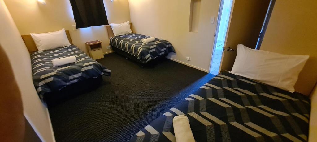 Postel nebo postele na pokoji v ubytování New Castle Motor Lodge